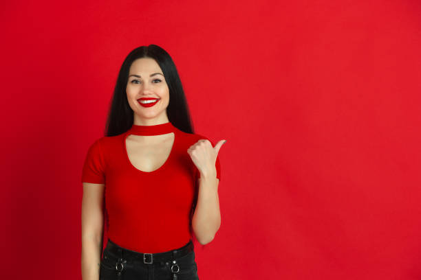 istock Caucasian young woman's monochrome portrait on red studio background, emotional and expressive 1221783036