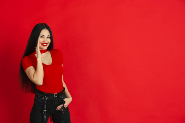 istock Caucasian young woman's monochrome portrait on red studio background, emotional and expressive 1221783054