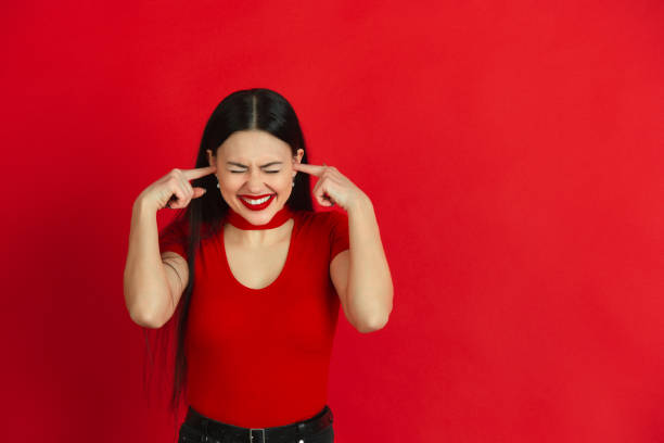 istock Caucasian young woman's monochrome portrait on red studio background, emotional and expressive 1221783076