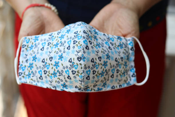 istock Female hand holing DIY handmade cloth face masks . 1221784593