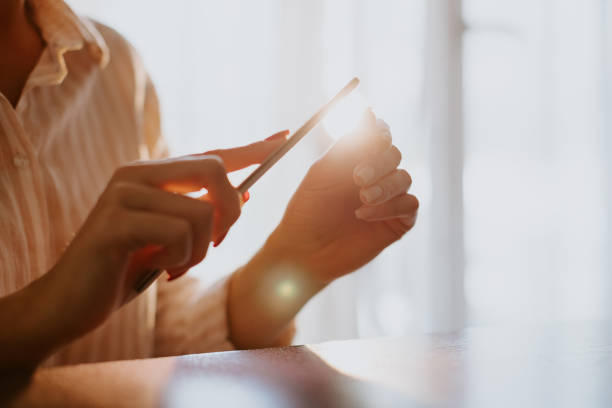 istock woman filing nails at home 1221788030