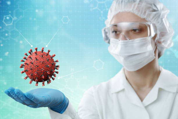 istock Innovative technologies in science and medicine . Female scientist holding a virus model in the palm of her hand. 1221789222