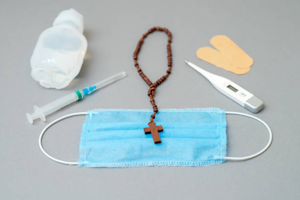 istock Medical mask with catholic cross. 1221789826