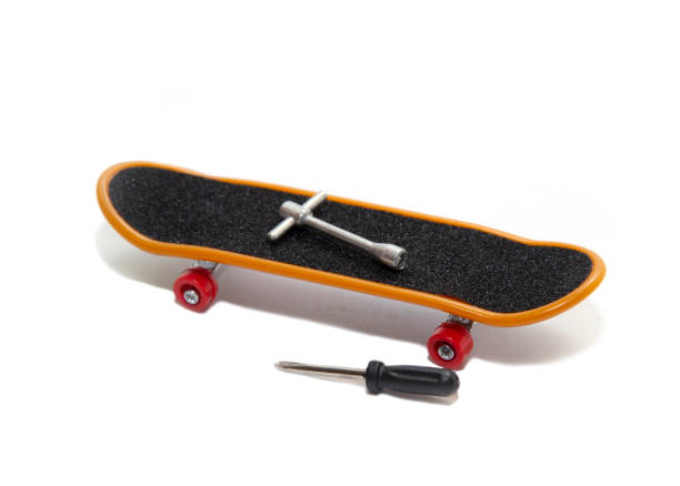 istock mini skateboard with screwdriver and wrench nearby. 1221789985
