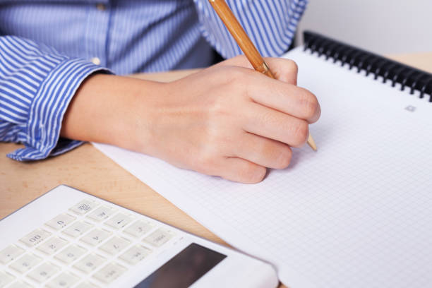 istock Business woman writing 1221790873