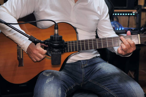 istock Guitarist playing and recording a nylon string guitar 1221791493