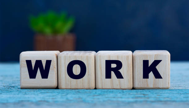 istock WORK the word on cubes on a background of old gray background with cactus 1221791496
