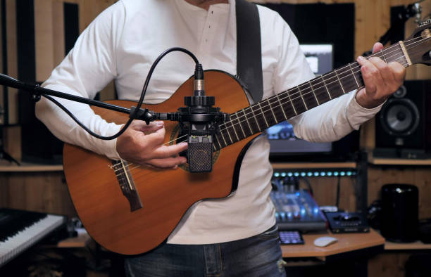 istock Guitarist playing and recording a nylon string guitar 1221791535