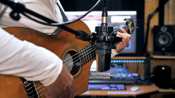 istock Guitarist playing and recording a nylon string guitar 1221791576