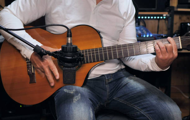 istock Guitarist playing and recording a nylon string guitar 1221791588