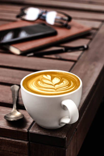 Barista latte art cappuccino on a wooden table