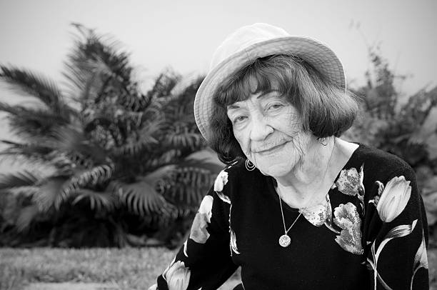 istock Senior woman looking at camera while sitting in backyard 122179314