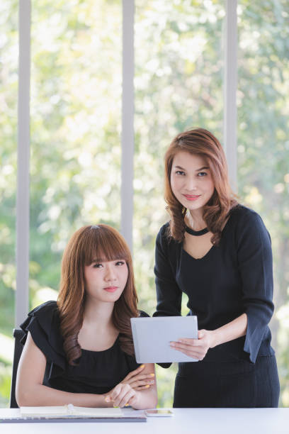 istock TWO BUSINESS LADIES IN OFFICE 1221793165
