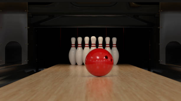 istock Red bowling ball on a wooden track with pins 1221793300