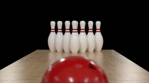 istock 3d render Red bowling ball on a black background with pins 1221793912