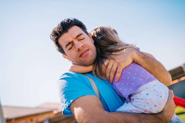 istock Father loving daughter in emotional hug 1221794099
