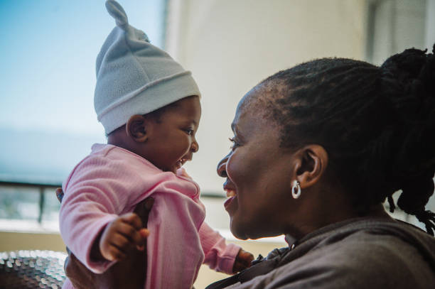 istock Grandmother and baby interacting side view laughter 1221796861