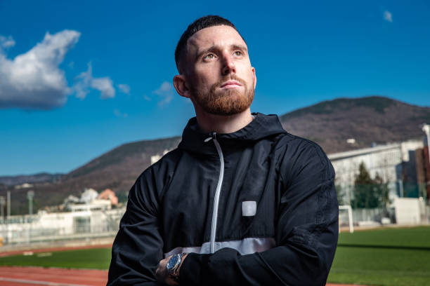 Young Pensive Athlete Portrait on the Stadium looking at view
