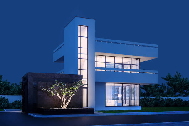 istock Modern house with white plaster with a balcony and a high staircase, in cold night light with warm light from the Windows against the background of trees and a white fence 3D stock illustration. 1221797248