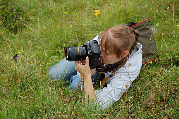 istock young female photographer in a meadow 122179733
