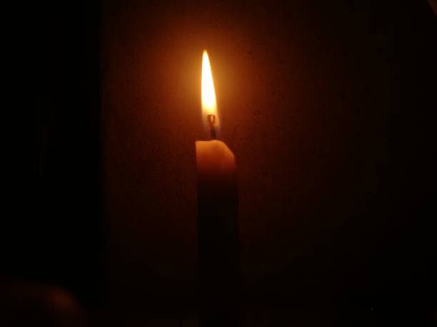 istock Candle burning in the dark 1221797612