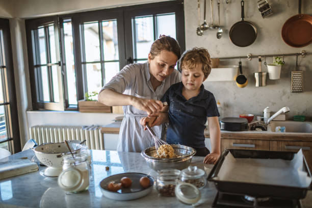 istock Mother and son making a Cake together 1221798558