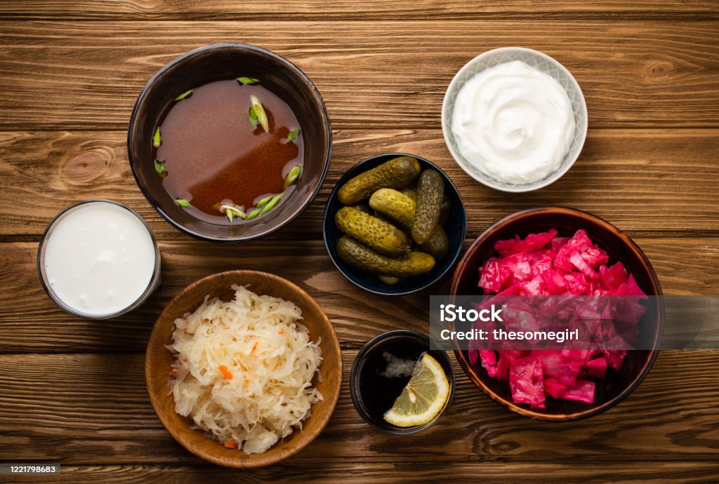 Assorted fermented foods Top view of assorted fermented foods and drinks, sources of probiotics great for healthy gut and digestive system: kimchi, pickles, sauerkraut, miso soup, kombucha, yogurt, kefir, wooden background Food Stock Photo