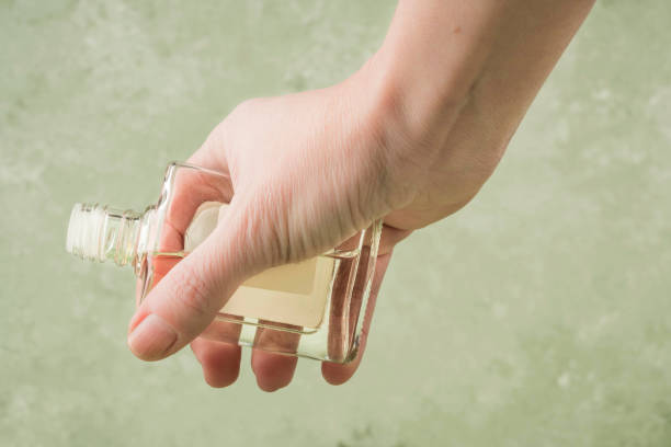 istock closeup hand holding a bottle of cologne 1221799079