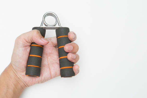 istock The hand is holding Hand grip for finger exercise on white background and copy space 1221800554