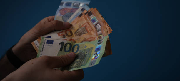 istock money in hand euro banknote 1221802078