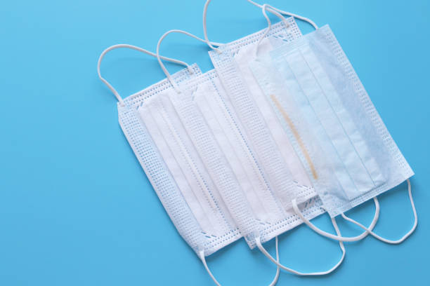 istock Medical disposable masks on a blue background 1221802126