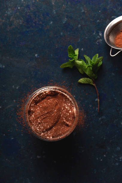 istock Serving of tiramisu garnished with cocoa and mint 1221803362