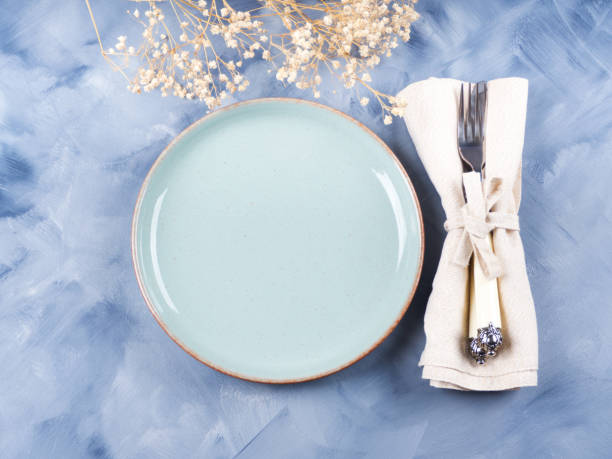 istock Blue pastel dish and silverware with dried flowers 1221803512