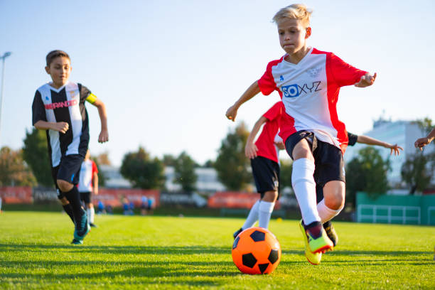 istock motivated children during professional soccer training match 1221803670