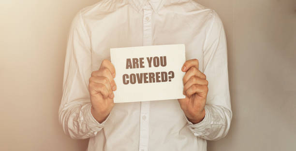 istock Are you Covered? written on a board with a business man on background 1221803961