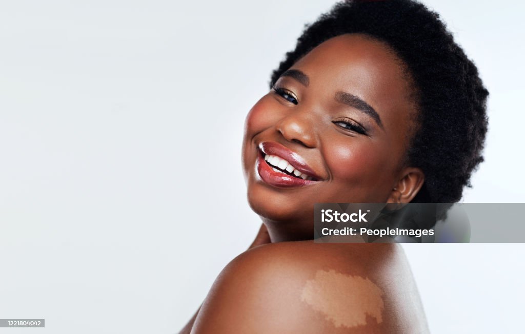 Love yourself, that's beautiful Studio shot of a beautiful young woman posing against a grey background Skin Care Stock Photo