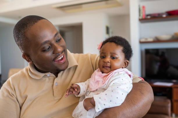istock Dad holding baby daughter in his arms 1221804741