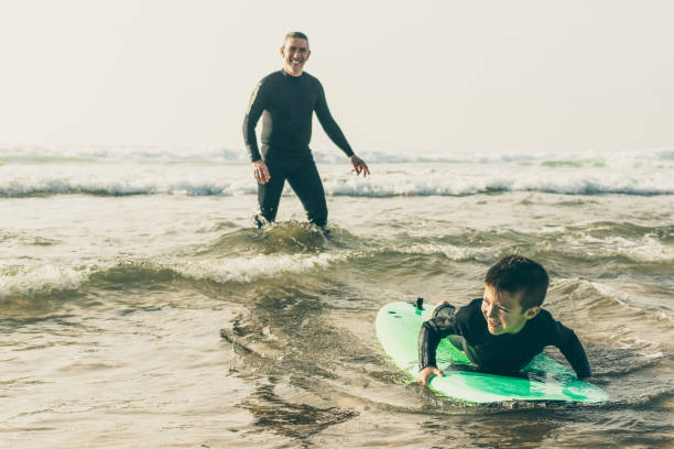 istock Adorable happy boy swimming on board 1221805209