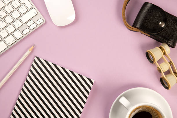 Office desk table top view with a coffee, computer keyboard and mouse and stationery supplies