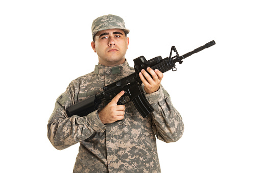 About 20 years old, Caucasian soldier with a rifle, isolated on white background.