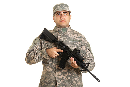 About 20 years old, Caucasian soldier with a rifle, isolated on white background.