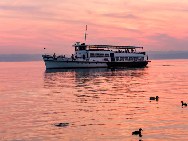 Passage of a ferry on Lake Garda in Sirmione, at sunset