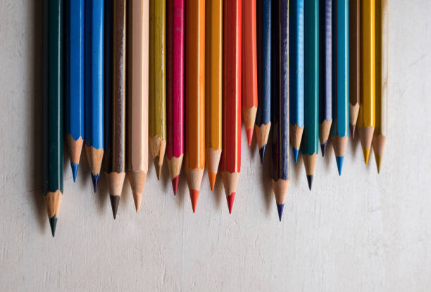 istock Colour pencils isolated on white wood background close up 1221817858