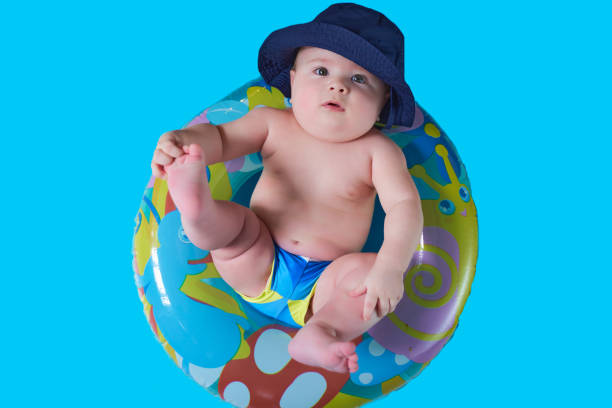 istock a funny little kid in a Panama hat sits in a bathing circle 1221819589