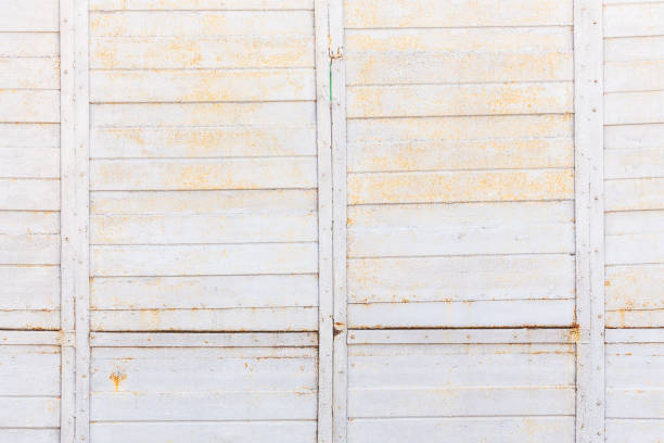 Grey abstract background with rust. Metal iron fence with stripes