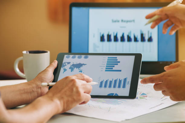 istock businessman working on project for analyzing company financial report balance statement with documents graphics at modern office space. Concept picture of business,economy, market,money and tax. 1221820893