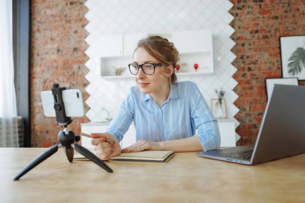 istock Woman watching online course on her phone 1221821450