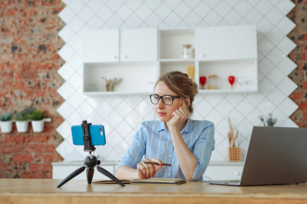 istock Woman watching online course with concentration on her phone 1221821497