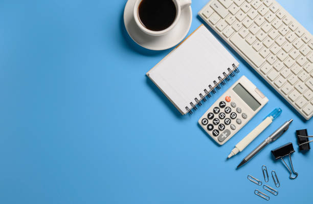 istock Top view,flat lay,notebook,pen,paperclip,coffee cup or object for office apply concept on blue background. 1221821807