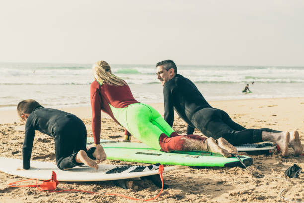 istock Family lying on surfboards on beach 1221822435